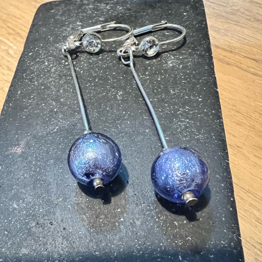 Purple glass drop earrings with lever back closure. Silver tone 2” dangle.